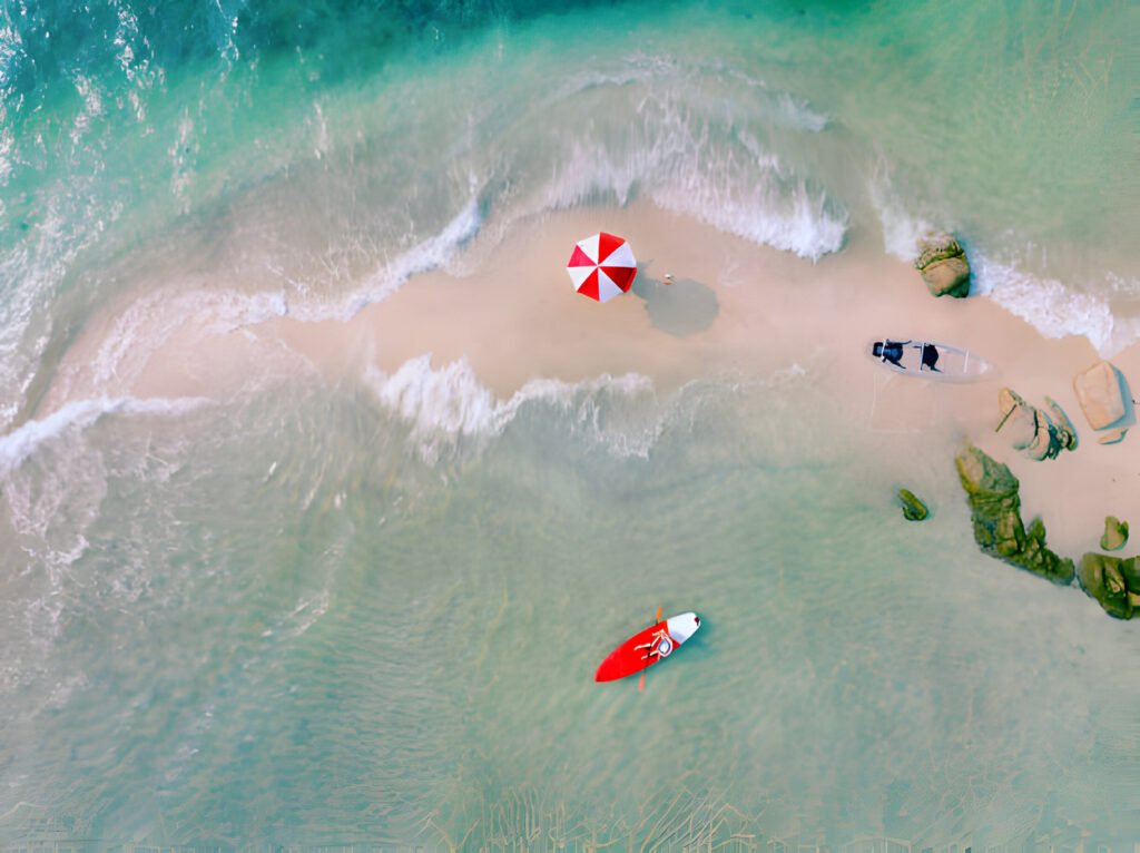 Digital Nomads in Thailand working on laptops in a beachside café with a beautiful ocean view in the background.